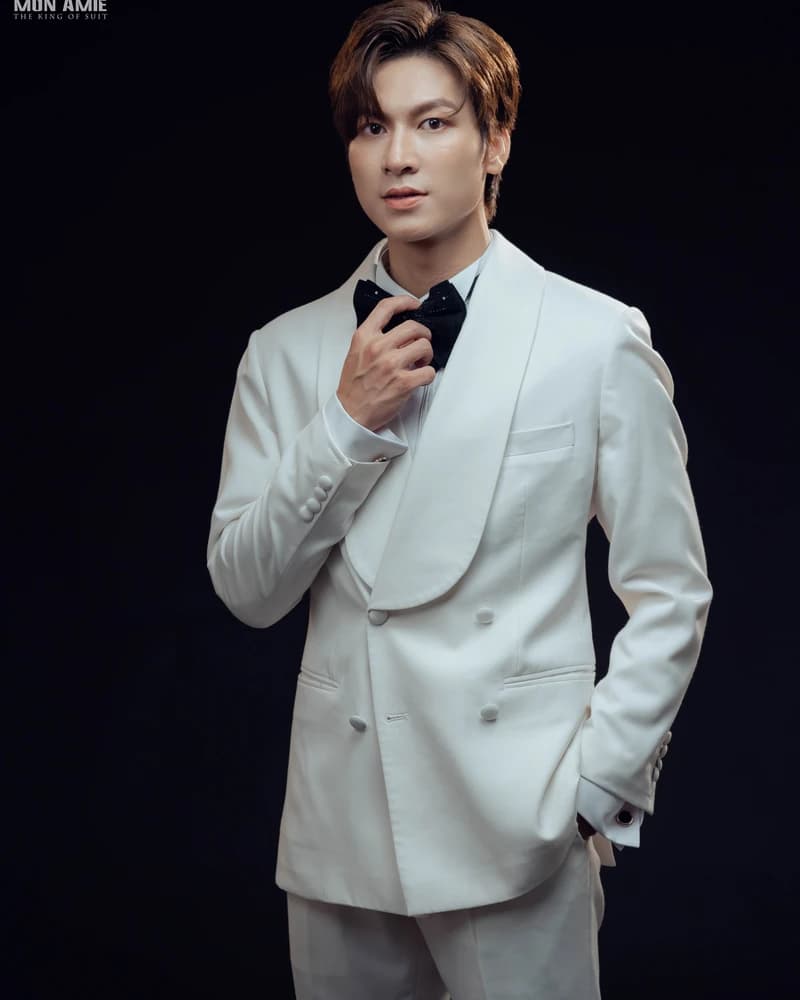Người mẫu mặc vest trắng cổ shawl và quần xám